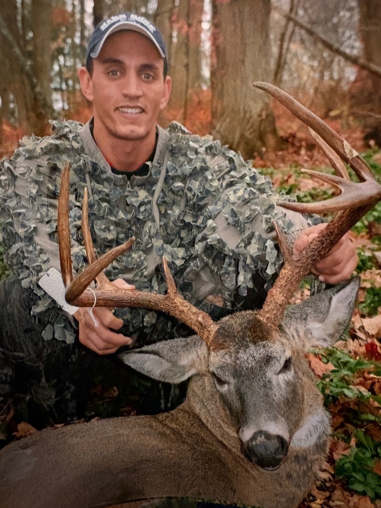 Young David with a buck in fall